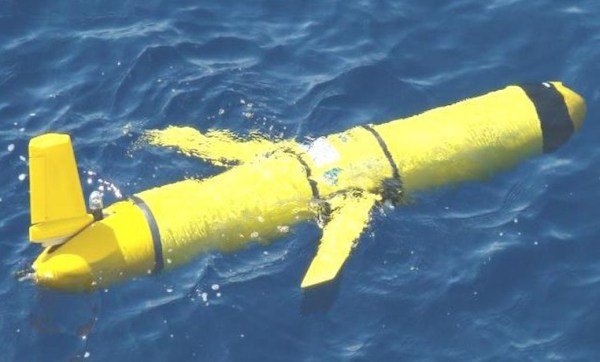 The image shows a yellow underwater drone in the sea. China is planning a project known as the Underwater Great Wall.